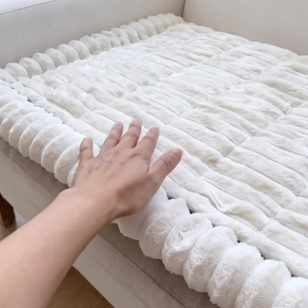 Hand smoothing the plush ribs and thick rounded edge of the white cover