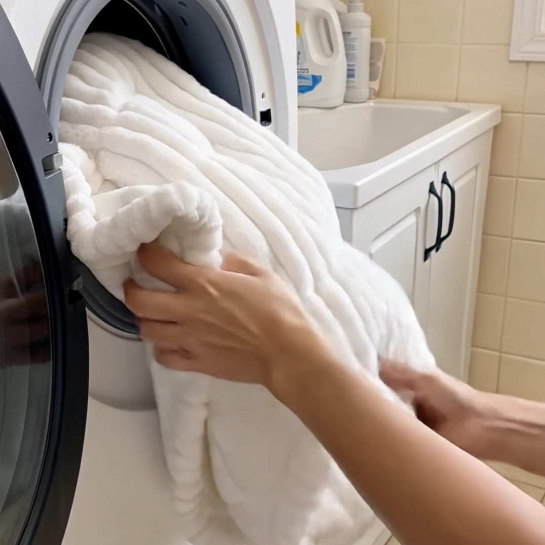 White plush cover being placed in a front-loading washing machine